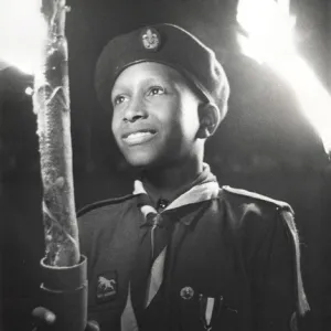 Boy of 3rd Bahamas Scout Troop in torchlight parade