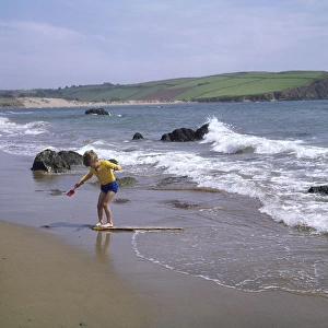 Boy on the beach at Bigbury Bay, Devon