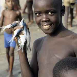 Boy with fishes, Sierra Leone