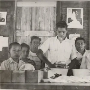 Boy scouts washing cutlery at camp, British Honduras