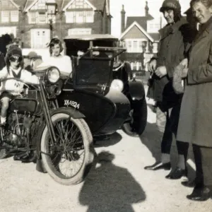 Boy sitting on a 1918 Harley Davidson motorcycle