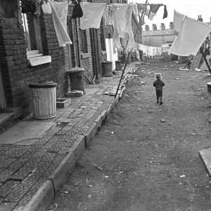 Boy in slum housing yard