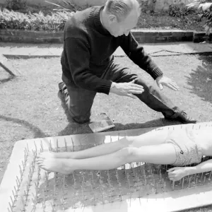 Boy stuntman on bed of nails