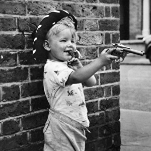 Boy with toy gun and cowboy hat, Balham, SW London