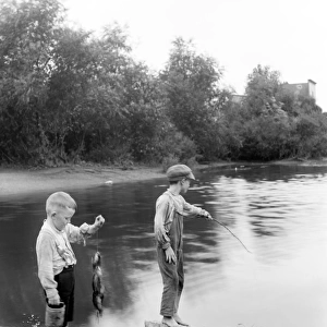 Boys fishing at a lake in Summit, Illinois, USA