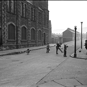 Boys playing football in a street, Belfast, Northern Ireland