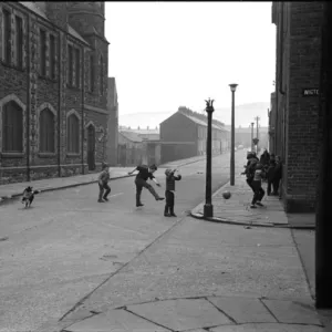 Boys playing football in a street, Belfast, Northern Ireland