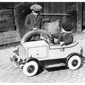 Boys playing with toy car, 1930s