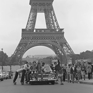 Boys riding on top of a car - Paris