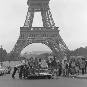 Boys riding on top of a car - Paris