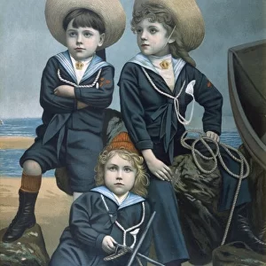 Three boys in sailor suits on beach