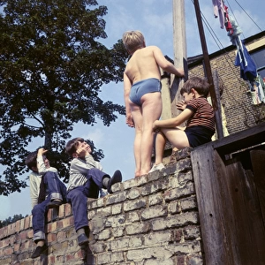 Four boys on a wall, with washing, Balham, SW London