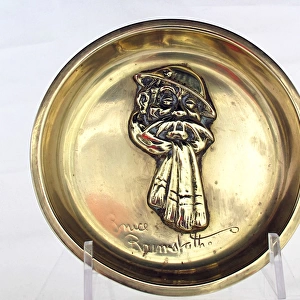 Brass ashtray with a fixed Old Bill head wearing a scar