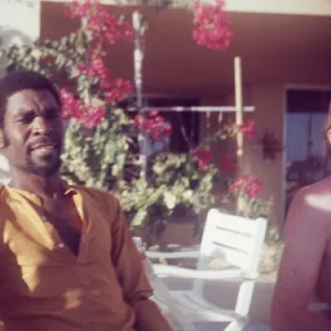 British Caribbean man sitting by pool at Holiday Inn Salalah