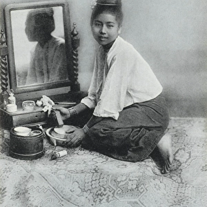 A Burmese girl preparing her make-up