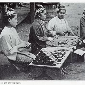 Burmese women rolling leaf tobacco into cigars. Date: 1908