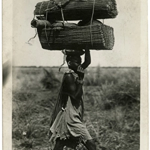 Carrying a heavy load on the head - Sudan
