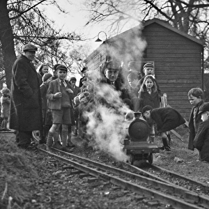 Children gathered around a miniature train