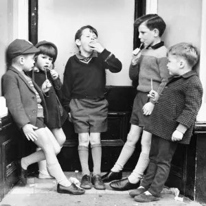 Children with ice lollies on a Balham street, SW London