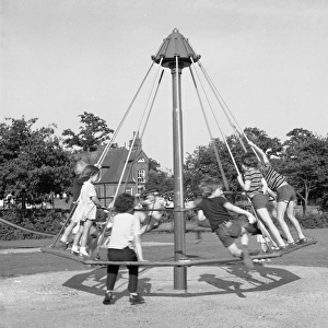 Children playing on an umbrella roundabout