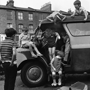 Children playing with a van in a Balham street, SW London