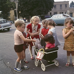 Children with toy pram, Balham, SW London