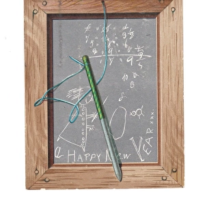 Childs slate with pen and scribbles on a New Year card