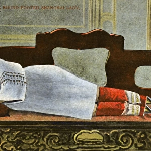 China - Shanghai - Woman with bound feet reclining on divan