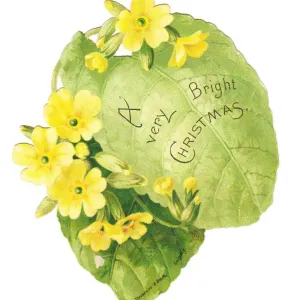 Christmas card in the shape of a green leaf with primroses Christmas card in the shape of a green leaf with primroses