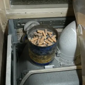 Cigarette butts in a tin Cigarette butts in a tin