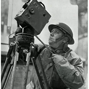 Cinematographer adjusts his camera, September 1939