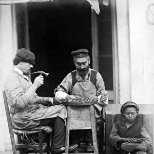 Cobblers at work, Naples, Italy