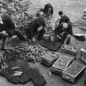 Communist China - sorting weapons and ammunition