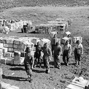 Compo ration dump and men carrying more supplies