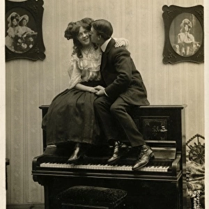 Couple canoodling on a piano