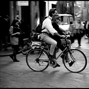 Couple on single bike, Pisa, Italy