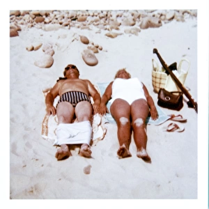 Couple sunbathing on a sandy beach