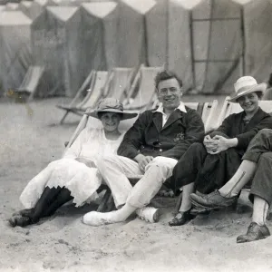 Couples sit in deckchairs on the beach at Margate, Kent