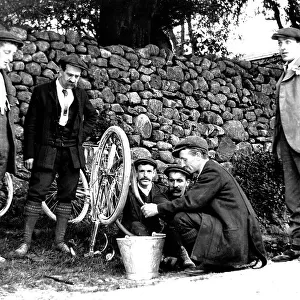 Cycling mending a puncture early 1900s