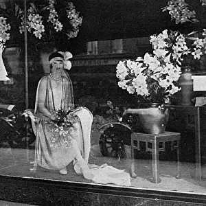 Debutante poses in a shop window, 1928