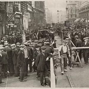 Disruption in Piccadilly, London, with crowds of people watching work being done on part