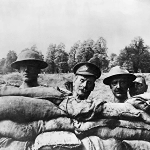 Dummy heads rising above the side of a trench, WW1
