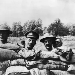 Dummy heads rising above the side of a trench, WW1