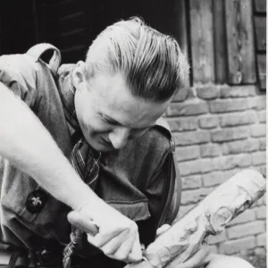 Dutch boy scout carving wood, Holland