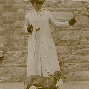 Edwardian woman with a dachshund on a lead