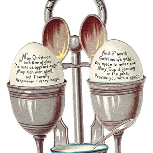Eggcup stand with two eggs on a cutout Christmas card