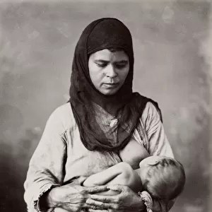 Egyptian woman breast-feeding a baby