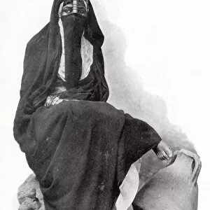 Egyptian woman from Cairo wearing traditional clothing. Date: 1902
