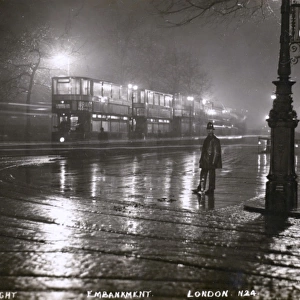The Embankment, London on wet night with Policeman and Trams