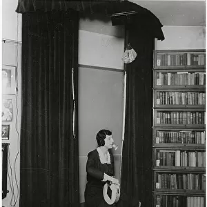 Ethel Beenham, Harry Price's secretary, demonstrates how a skilful medium can perform any number of psychic phenomena even though her hands and feet are tied. Date: 1930s ?